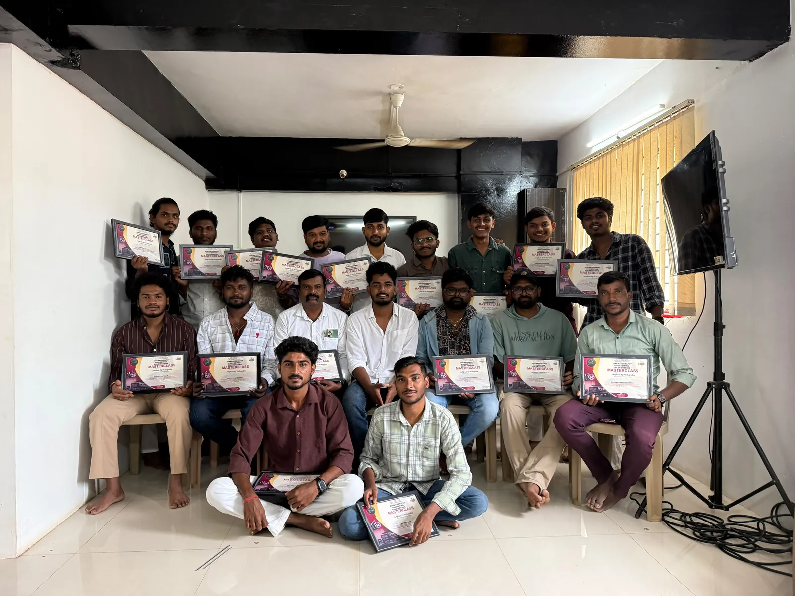 Students of a completed SVM Photography batch holding their Cinematography, Video Editing and Colour Grading Masterclass certificates at the Hubballi centre